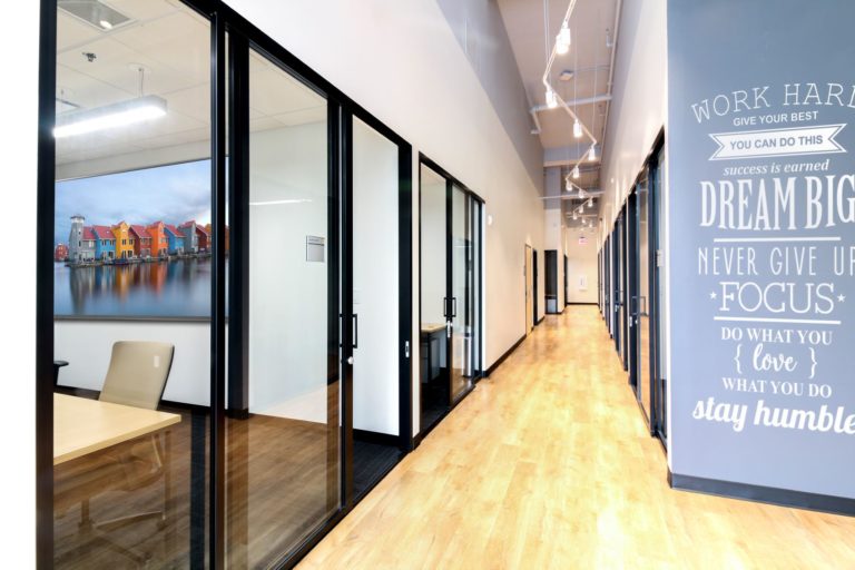 Row of modern offices with clear glass sliding door panels