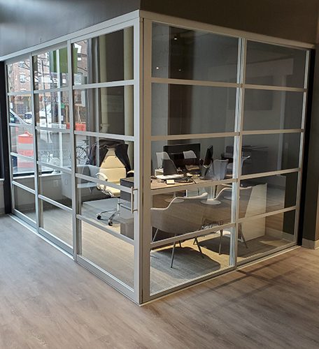 Enclosed glass corner office with modern sliding doors