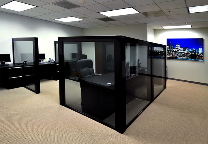 Modern office work station separated by fixed glass panels