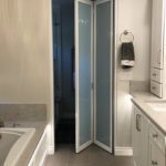 Bathroom bi fold white frame glass doors