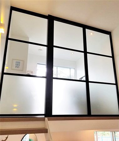 Glass door divides loft on the second floor