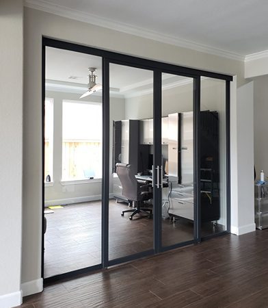 Glass sliding door divides living room and home office