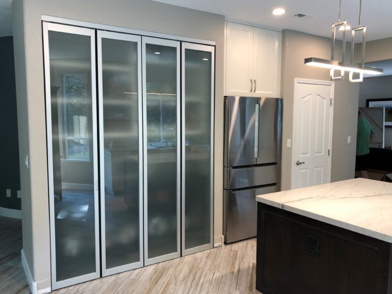Kitchen space with bi fold kitchen pantry doors
