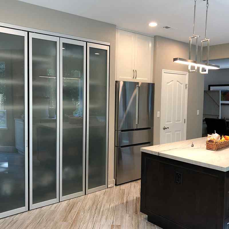 Kitchen pantry with bi folding doors with frosted glass