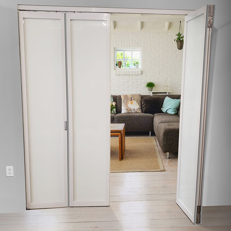 Bifold glass door splits living room area from the hallway
