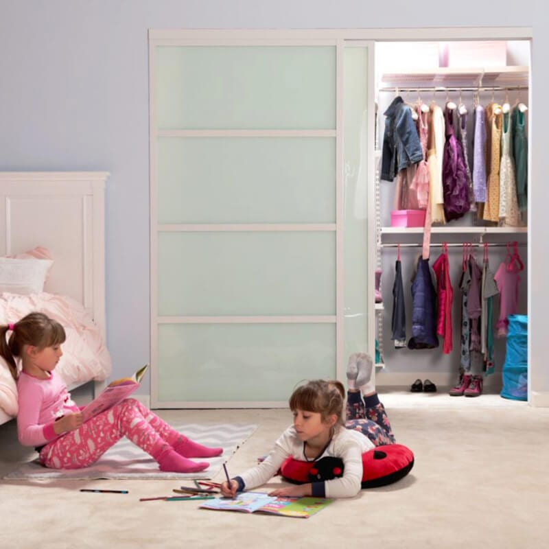 Two kids are playing in the room next to white glass closet door
