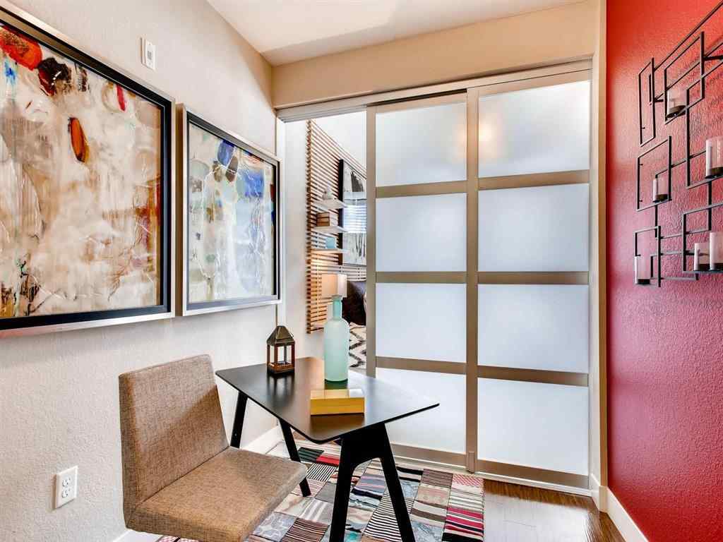 Frosted glass sliding door divides reading room with two pictures on the wall 