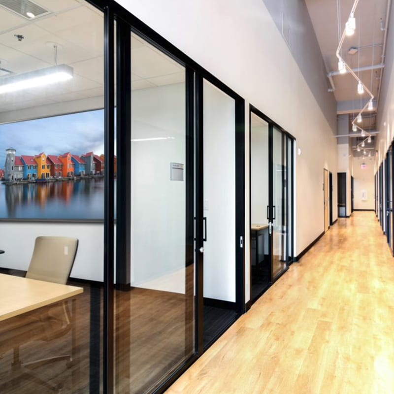 Row of corporate offices with clear glass fixed panels and sliding doors