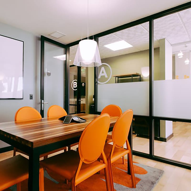 Small meeting room desk and chairs with fix glass panels and swing door