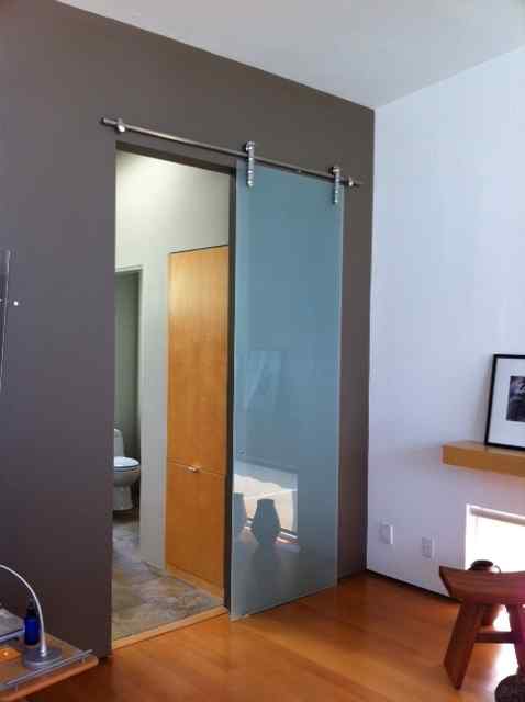 Frameless barn door bathroom glass