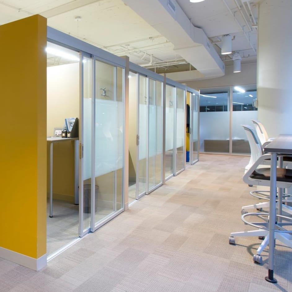 Glass sliding doors enclosing cubicles