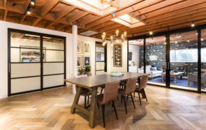 Table and chairs in the living room with glass sliding door space dividers