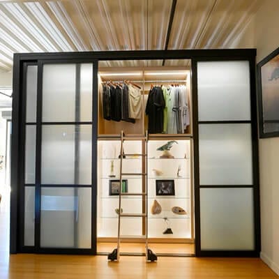 Frosted glass closet door splits closet from the rest of the area