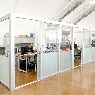 car dealership with qubiglass glass enclosures for private offices