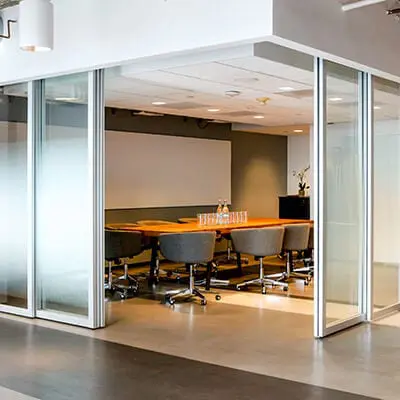 Clear glass sliding door divides meeting room