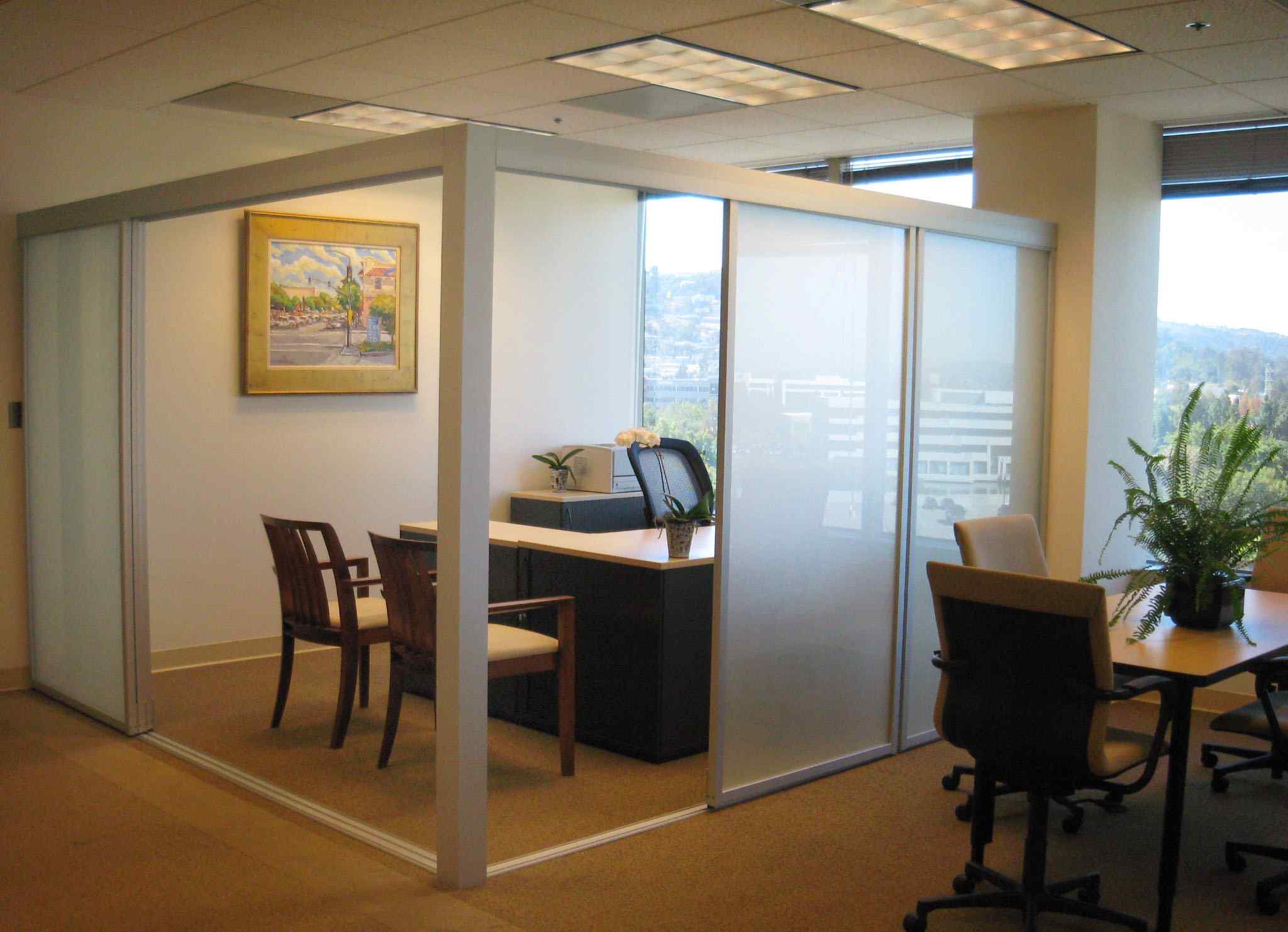 Enclosed frosted glass corner home office with modern sliding doors