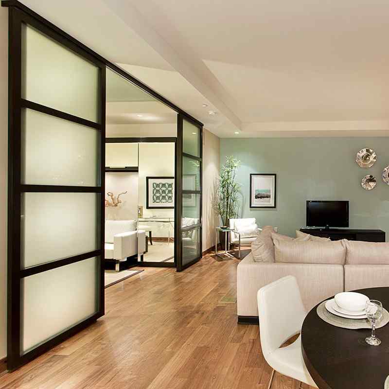 Frosted glass sliding door divides living room space 