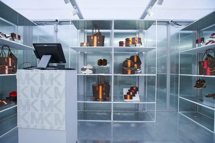 Bag section at Michael Kors frosted glass kiosk boutique
