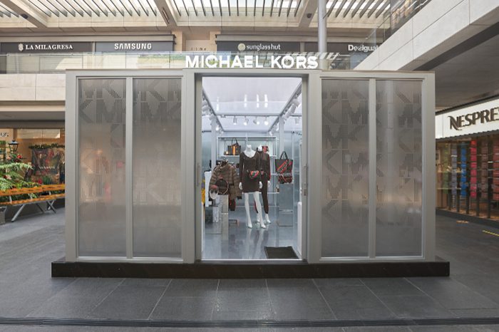 Michael Kors frosted glass sliding door kiosk