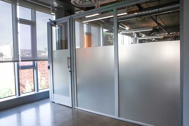 Frosted door panels and swing door divides lab from rest of the area