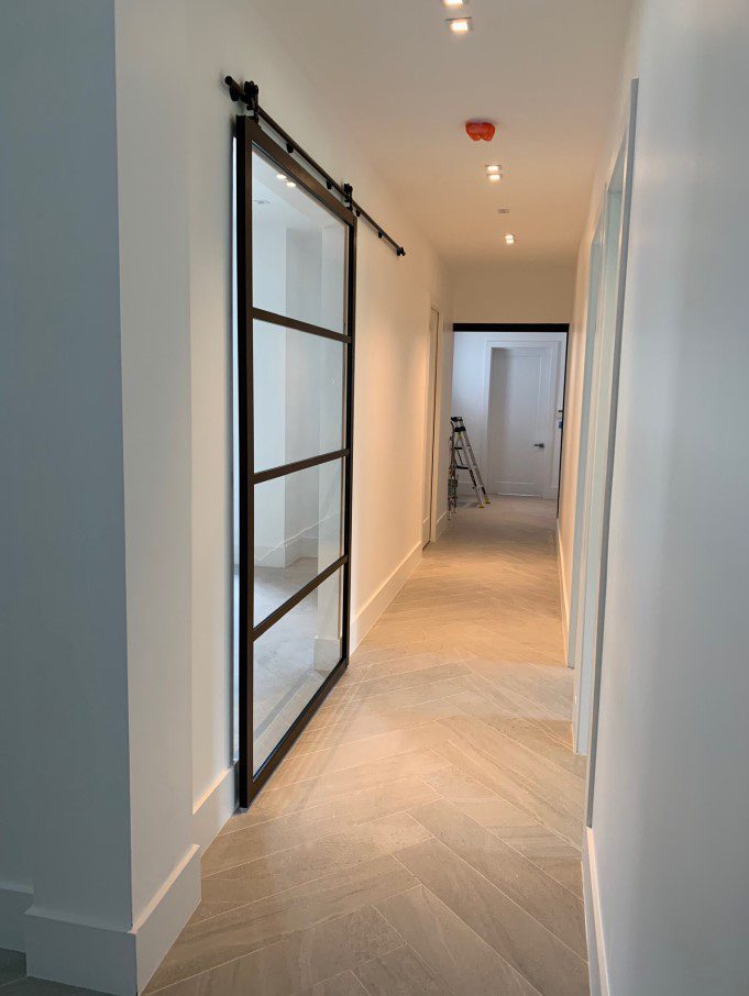 Single suspended barn door divider hallway and room