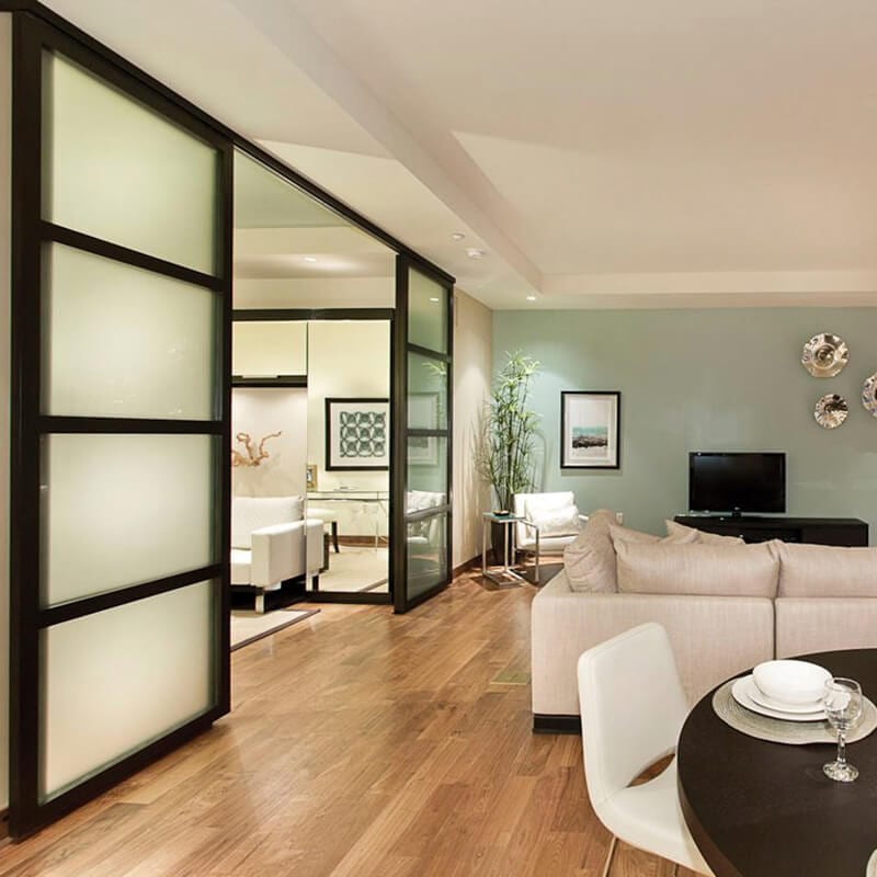 Glass suspended doors divides modern living room area