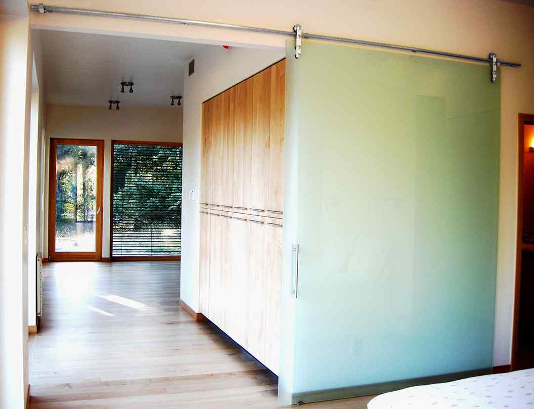 bedroom with high end frameless glass barn door