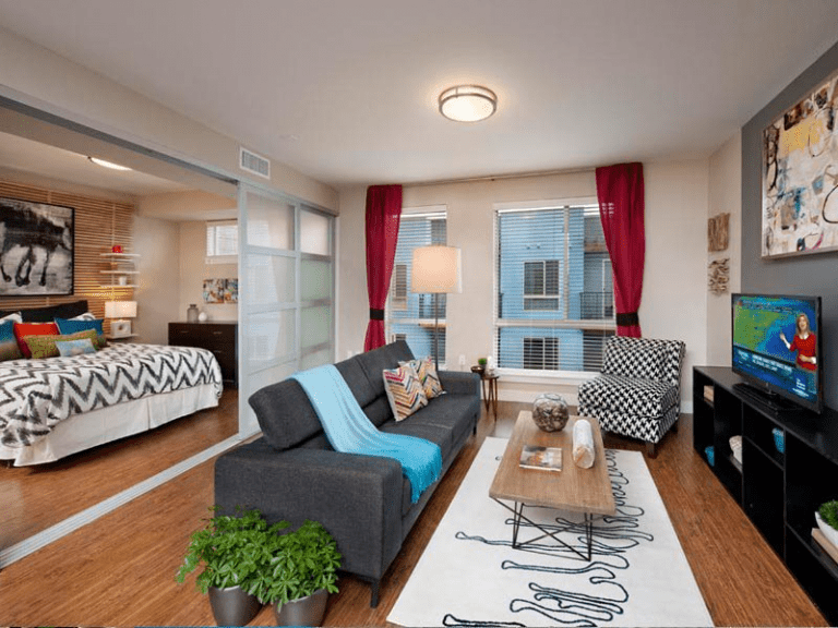 bright furnished living room with divider sliding doors