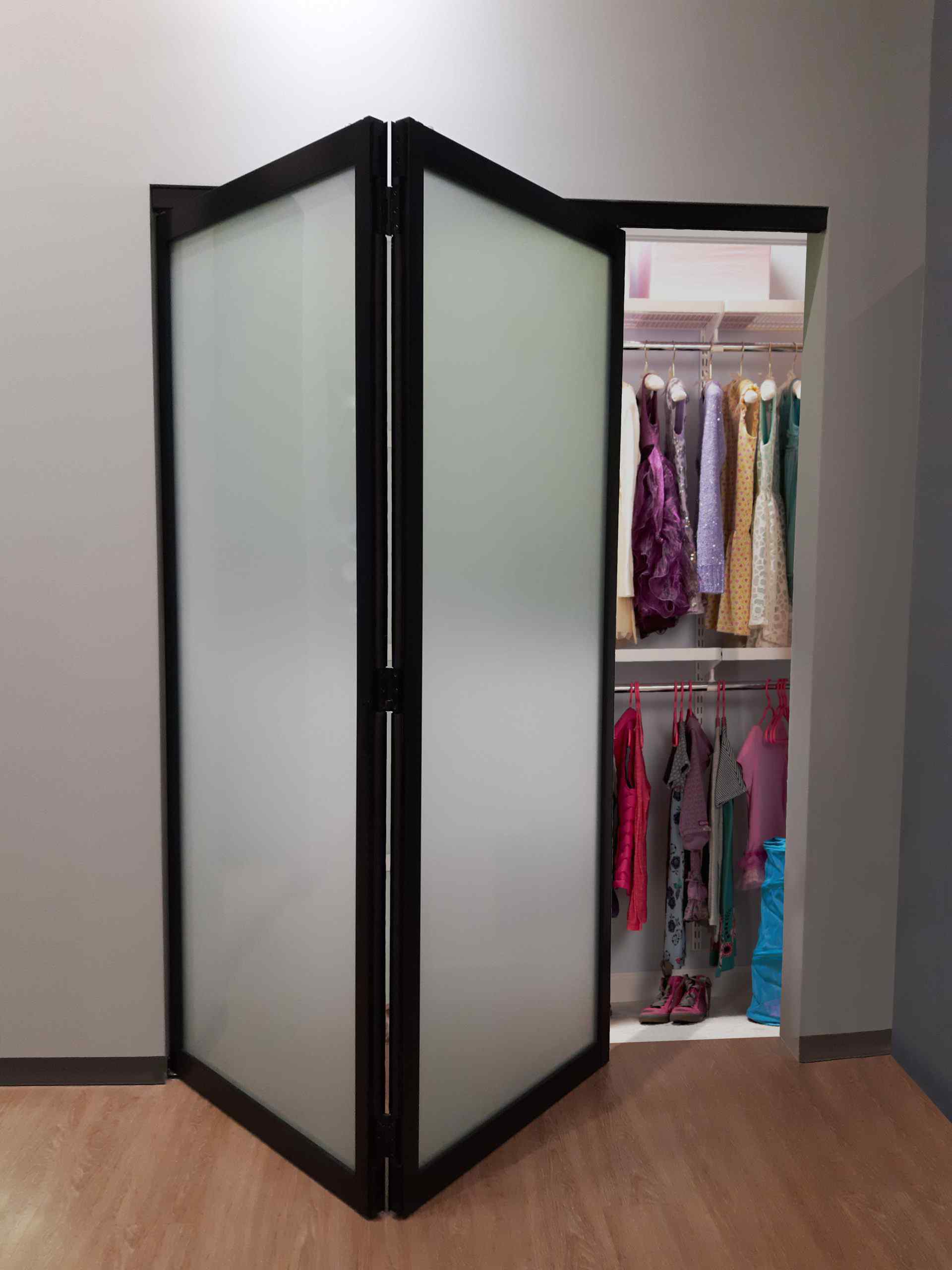 closet with black bi fold frosted glass doors