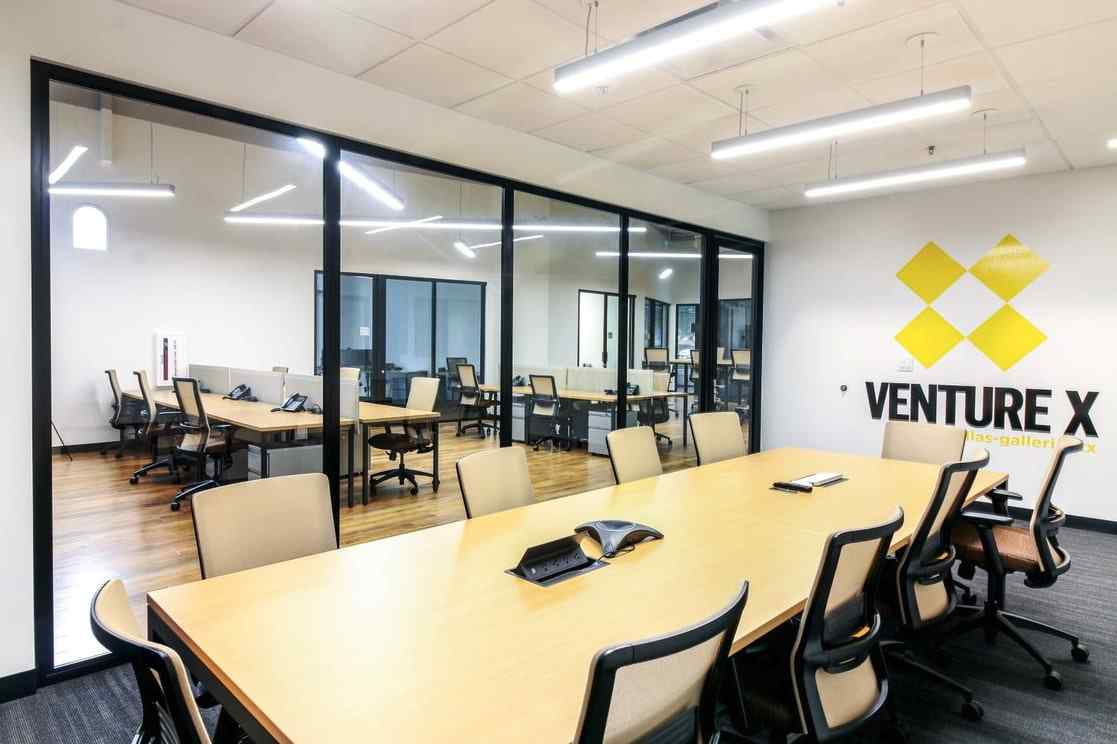 conference room with glass wall panels and glass swing door