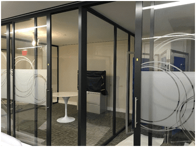 Enclosed glass corner office with modern sliding doors