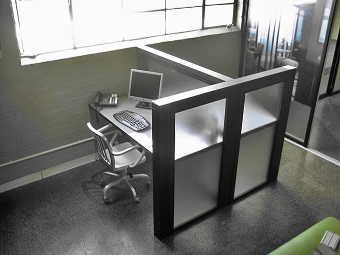 Modern office booth working station separated by fixed frosted glass panels