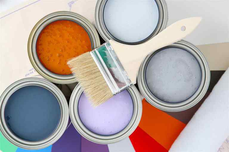 paintbrush on paint tins