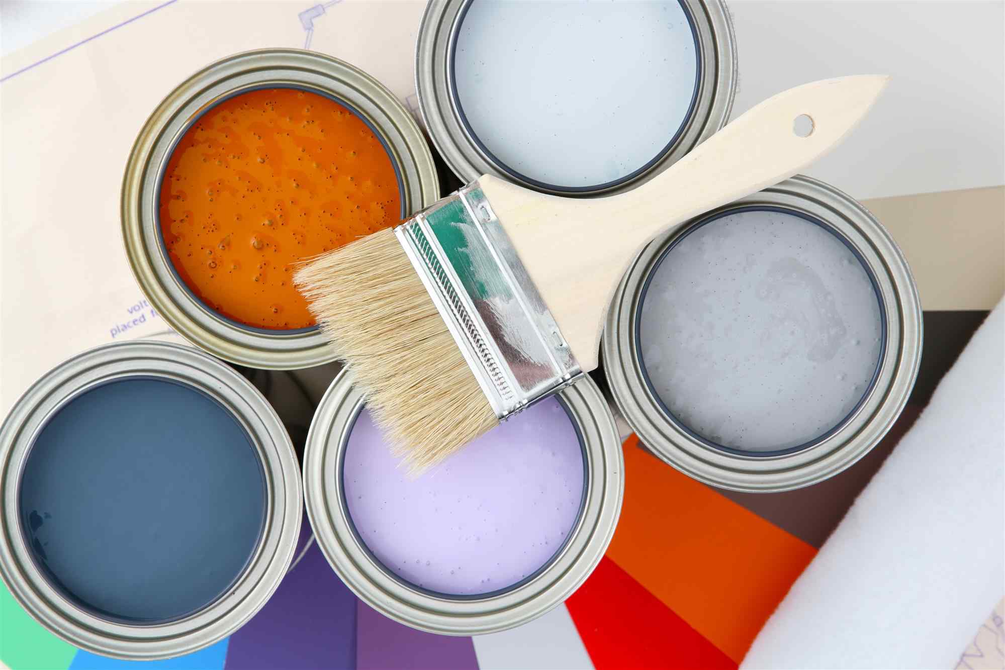 paint brush on paint tins